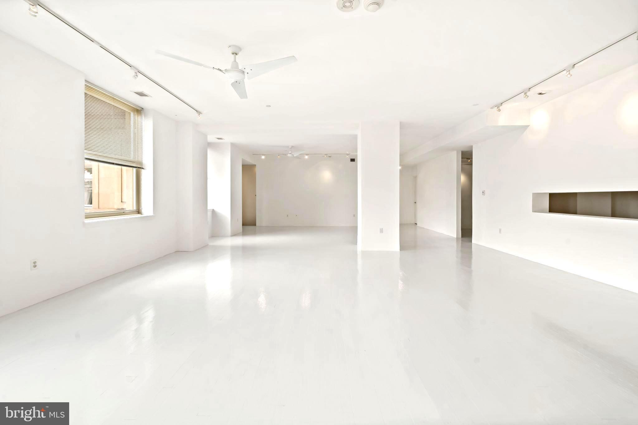 1600 Arch Street, Unit 1809 Philadelphia, PA 19103 - Photo 16 of 36 a view of a big room with windows and chandelier fan