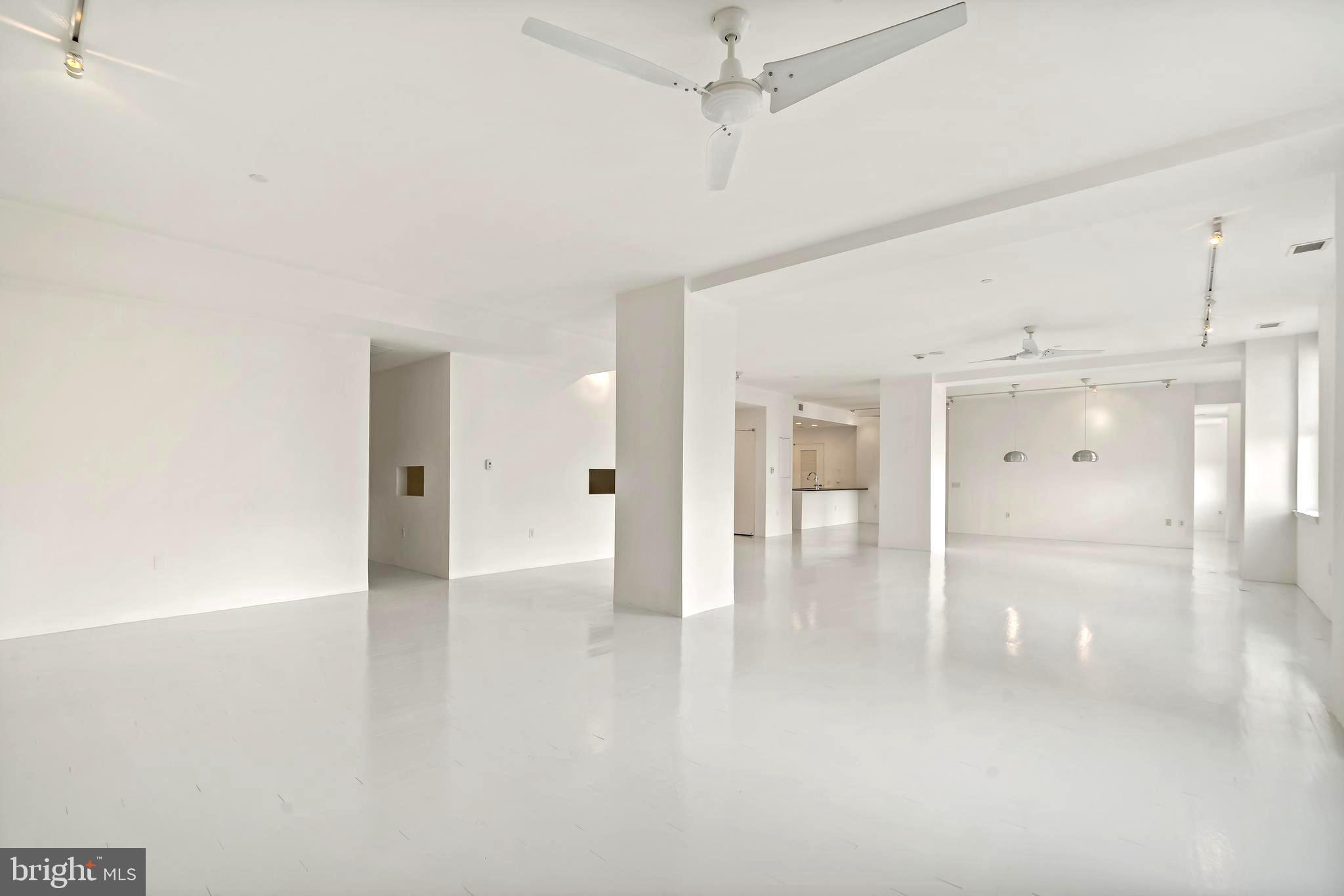 1600 Arch Street, Unit 1809 Philadelphia, PA 19103 - Photo 17 of 36 an empty room with wooden floor and windows