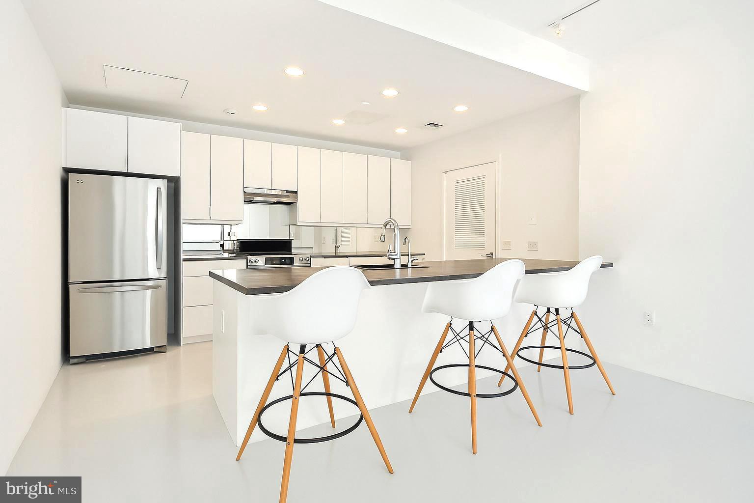 1600 Arch Street, Unit 1809 Philadelphia, PA 19103 - Photo 2 of 36 a kitchen with stainless steel appliances kitchen island a refrigerator sink and cabinets