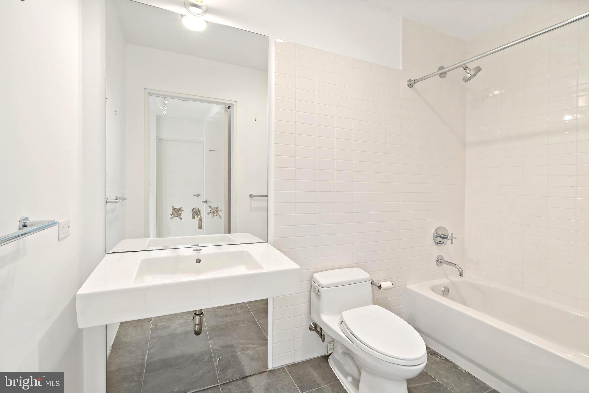 1600 Arch Street, Unit 1809 Philadelphia, PA 19103 - Photo 21 of 36 a bathroom with a sink toilet tub and shower