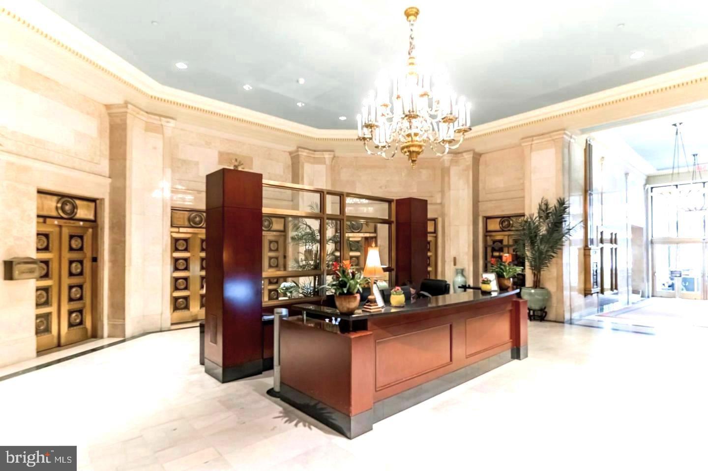 1600 Arch Street, Unit 1809 Philadelphia, PA 19103 - Photo 28 of 36 a living room with couch a large window and a chandelier