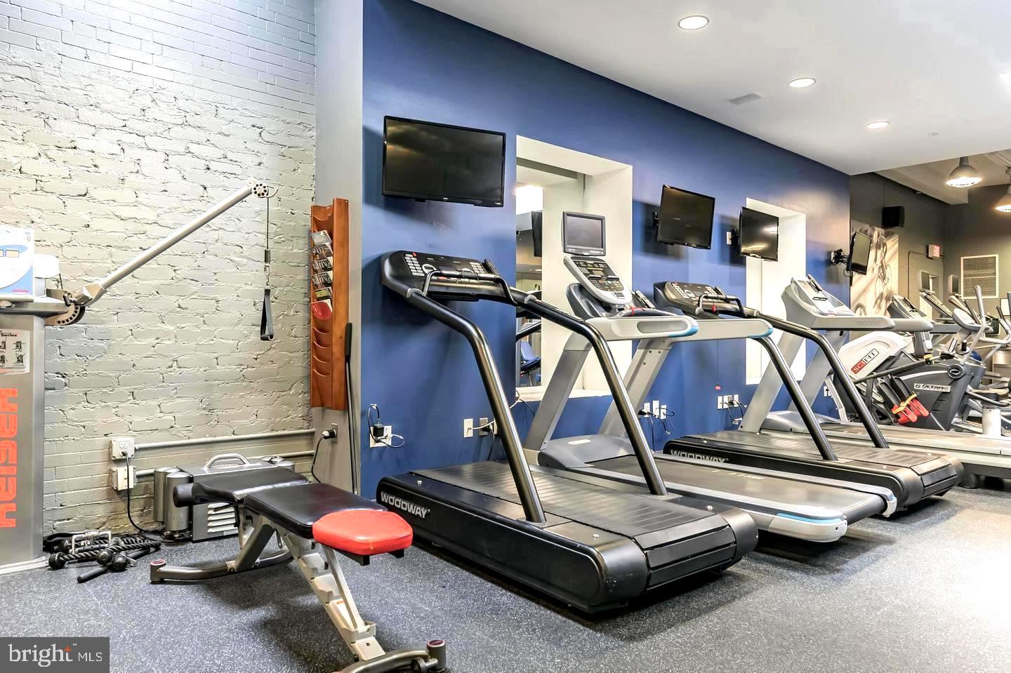 1600 Arch Street, Unit 1809 Philadelphia, PA 19103 - Photo 30 of 36 a room with gym equipment and flat screen tv