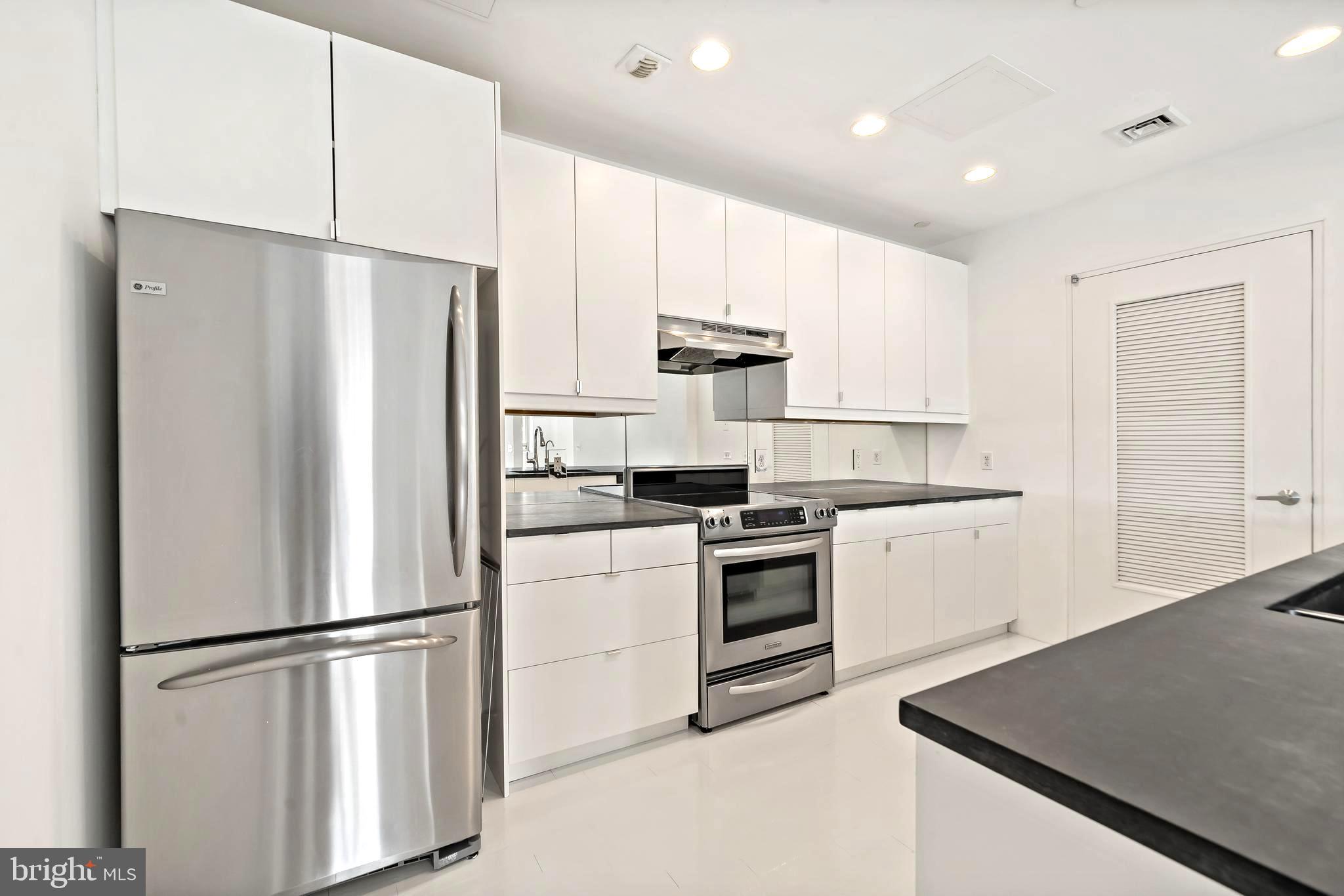 1600 Arch Street, Unit 1809 Philadelphia, PA 19103 - Photo 3 of 36 a white refrigerator freezer sitting in a kitchen