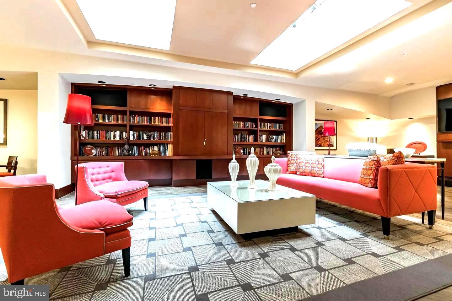 1600 Arch Street, Unit 1809 Philadelphia, PA 19103 - Photo 33 of 36 a living room with furniture a rug and a book shelf