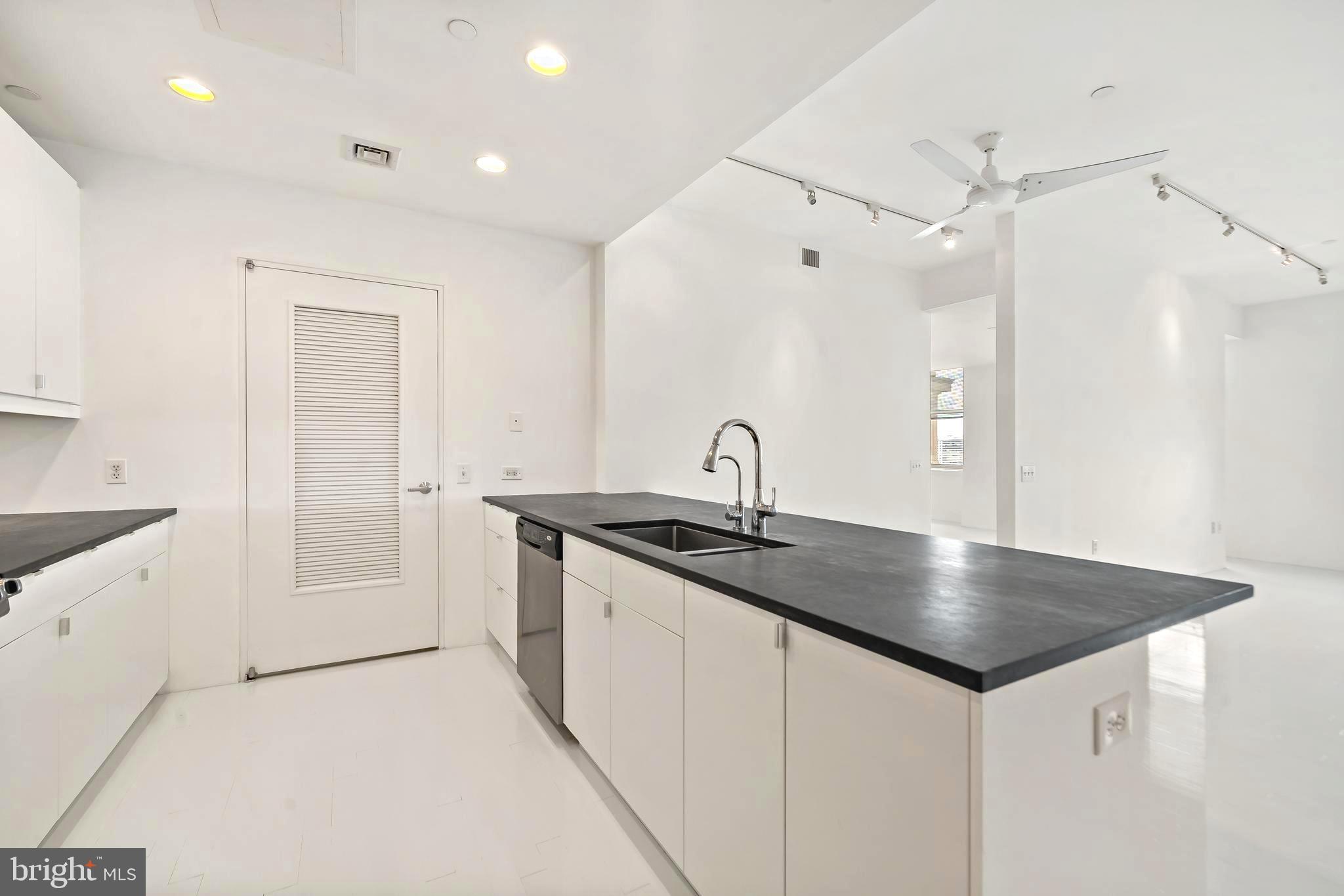 1600 Arch Street, Unit 1809 Philadelphia, PA 19103 - Photo 4 of 36 a kitchen with granite countertop a sink and refrigerator