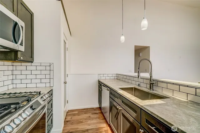 a kitchen with a sink and a stove