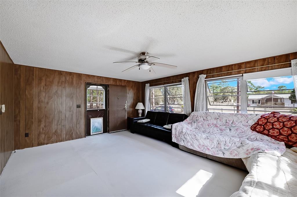 123 Miller Road Pomona Park, FL 32181 - Photo 13 of 36 a bedroom with a large bed and a large window