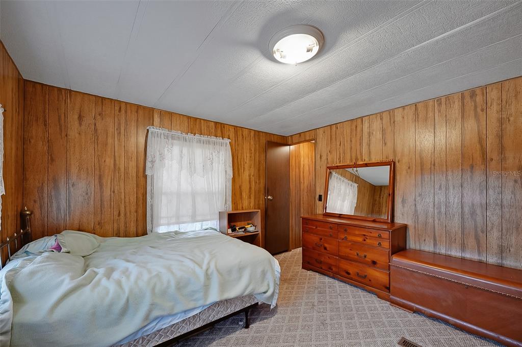 123 Miller Road Pomona Park, FL 32181 - Photo 19 of 36 a bedroom with a bed dresser and a large window