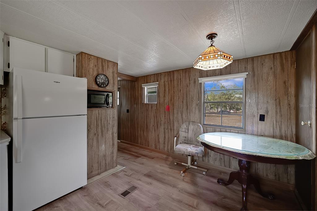 123 Miller Road Pomona Park, FL 32181 - Photo 23 of 36 a view of a kitchen with a table and chairs