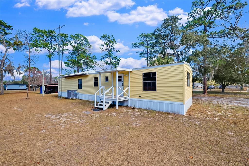 123 Miller Road Pomona Park, FL 32181 - Photo 29 of 36 a view of a house with backyard and sitting area