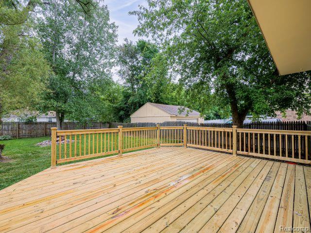 21728 Ruth Street Farmington, MI 48336 - Photo 47 of 54 Spacious outdoor deck with natural wood planks and matching railing