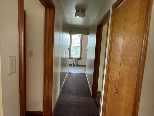 a view of hallway with wooden floor