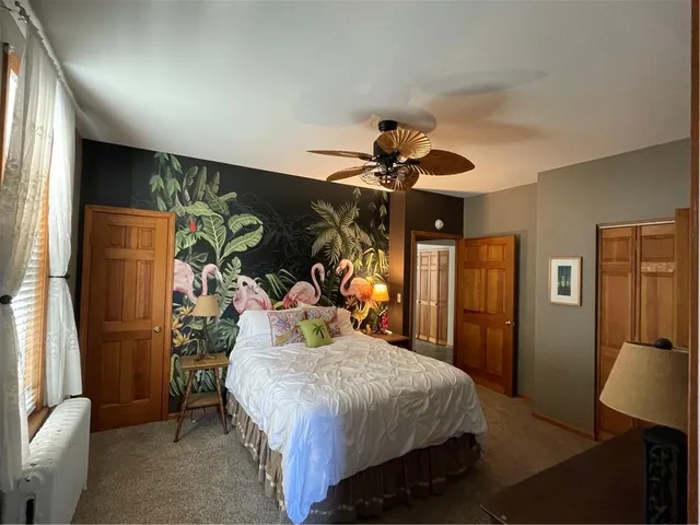 a bedroom with a large bed and a chandelier