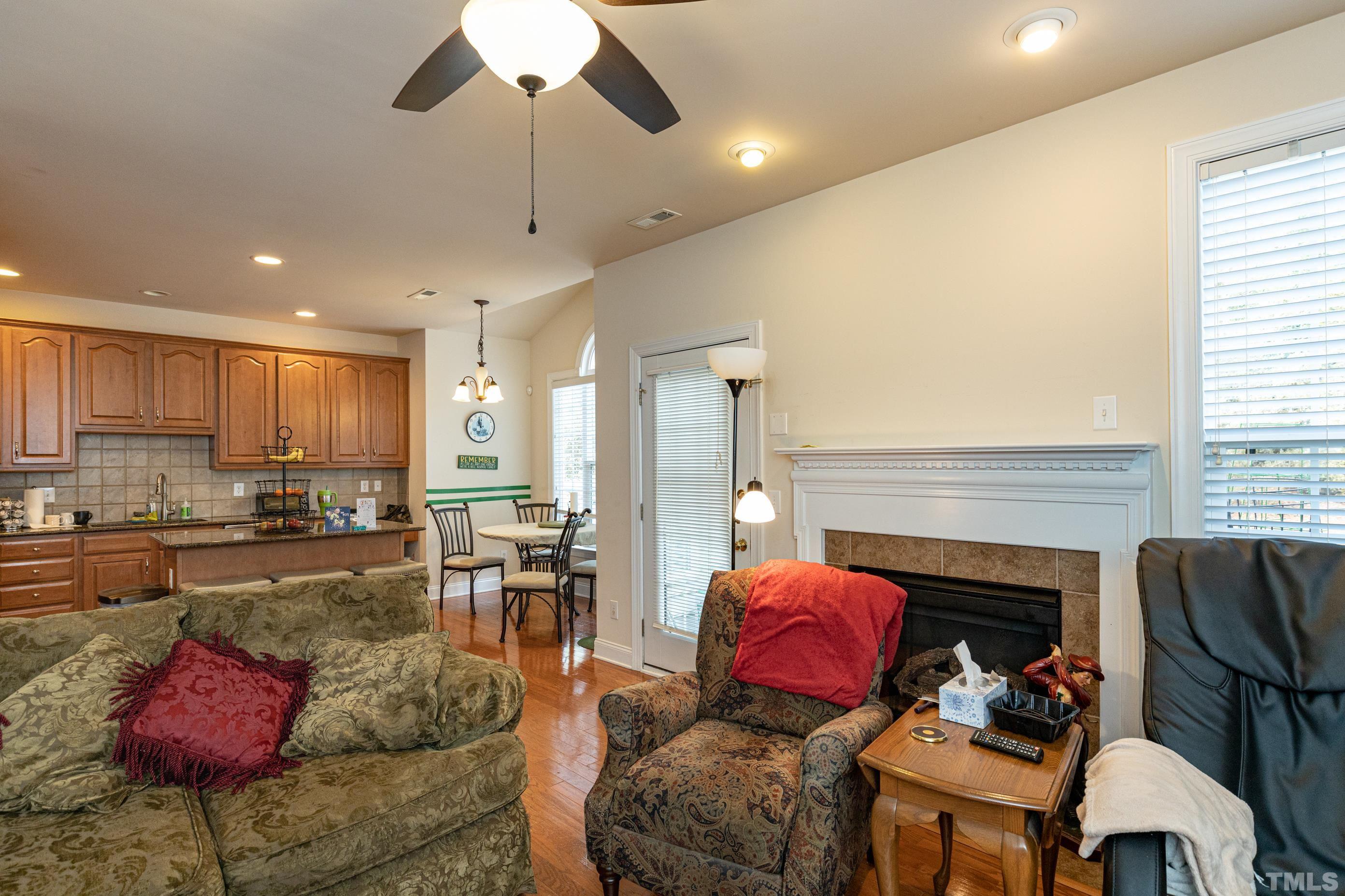 11210 Maplecroft Court Raleigh, NC 27617 - Photo 12 of 30 a living room with furniture fireplace and dining room