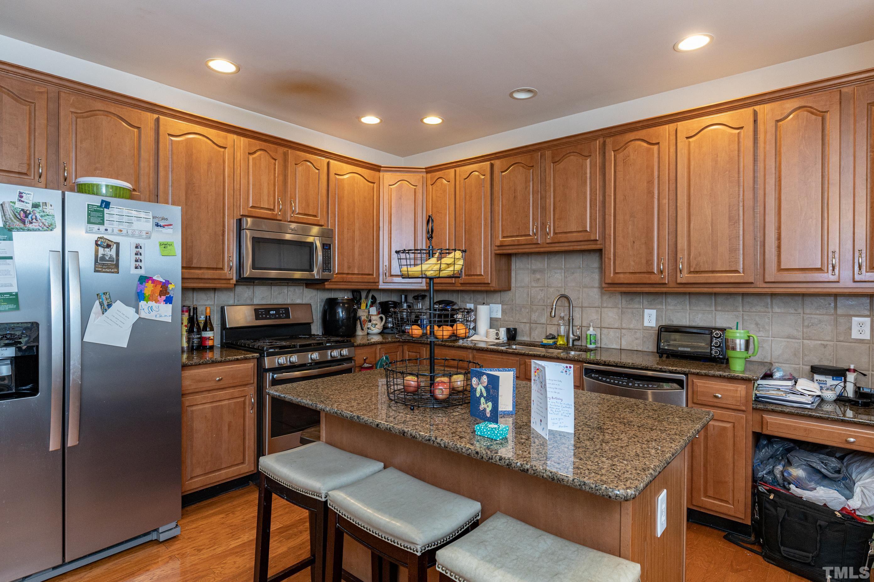 11210 Maplecroft Court Raleigh, NC 27617 - Photo 14 of 30 a kitchen with stainless steel appliances granite countertop a refrigerator a stove top oven a sink and dishwasher