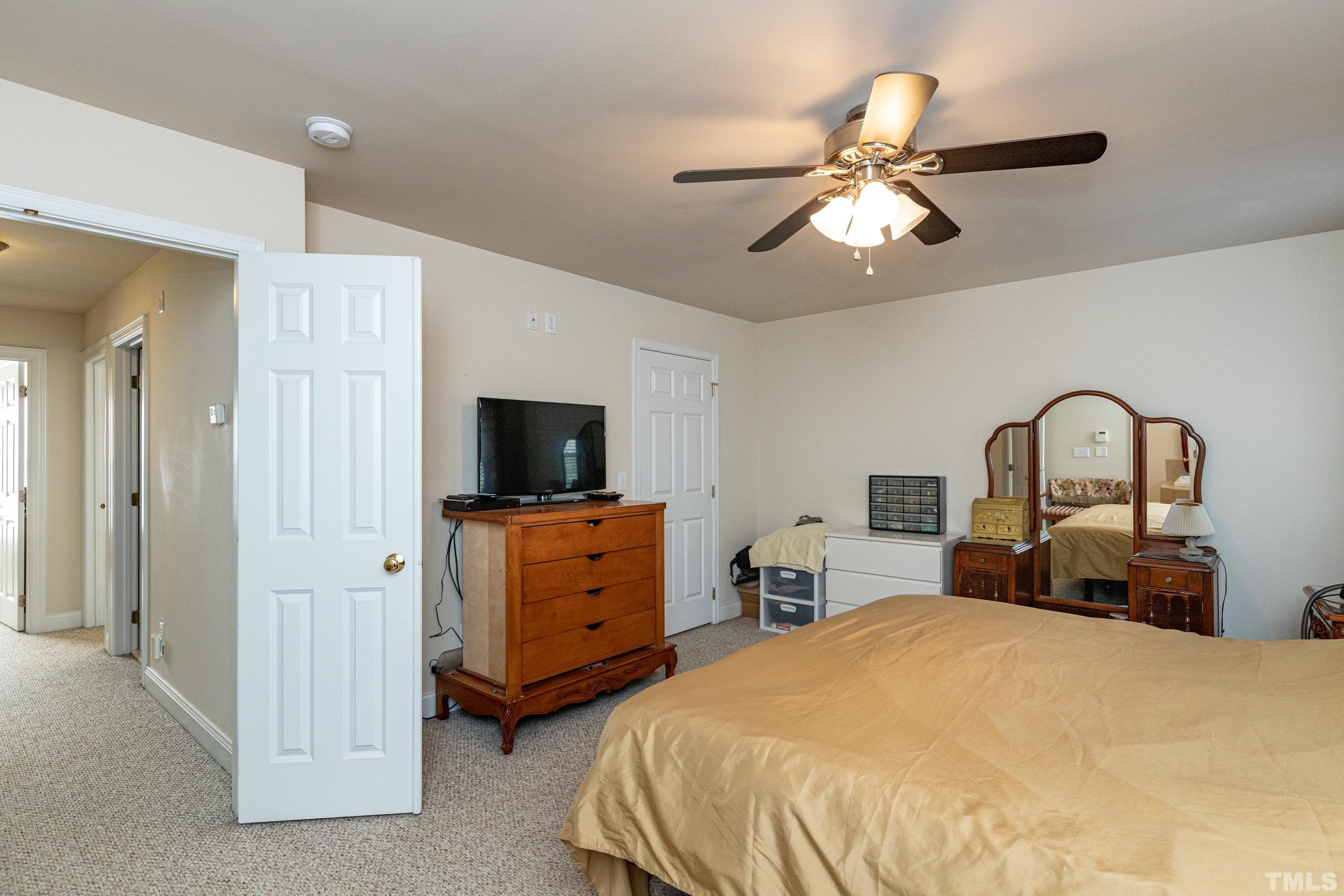11210 Maplecroft Court Raleigh, NC 27617 - Photo 19 of 30 a bedroom with bed and a chandelier