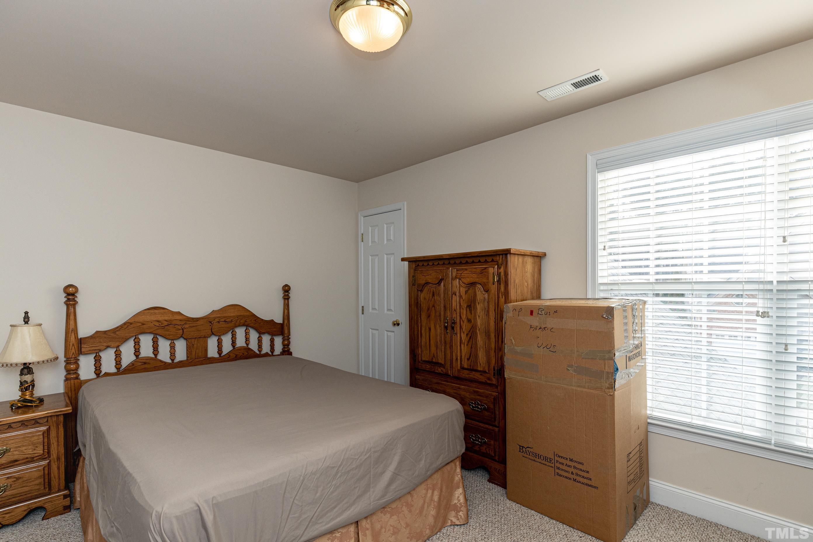 11210 Maplecroft Court Raleigh, NC 27617 - Photo 25 of 30 a bedroom with a bed and a window