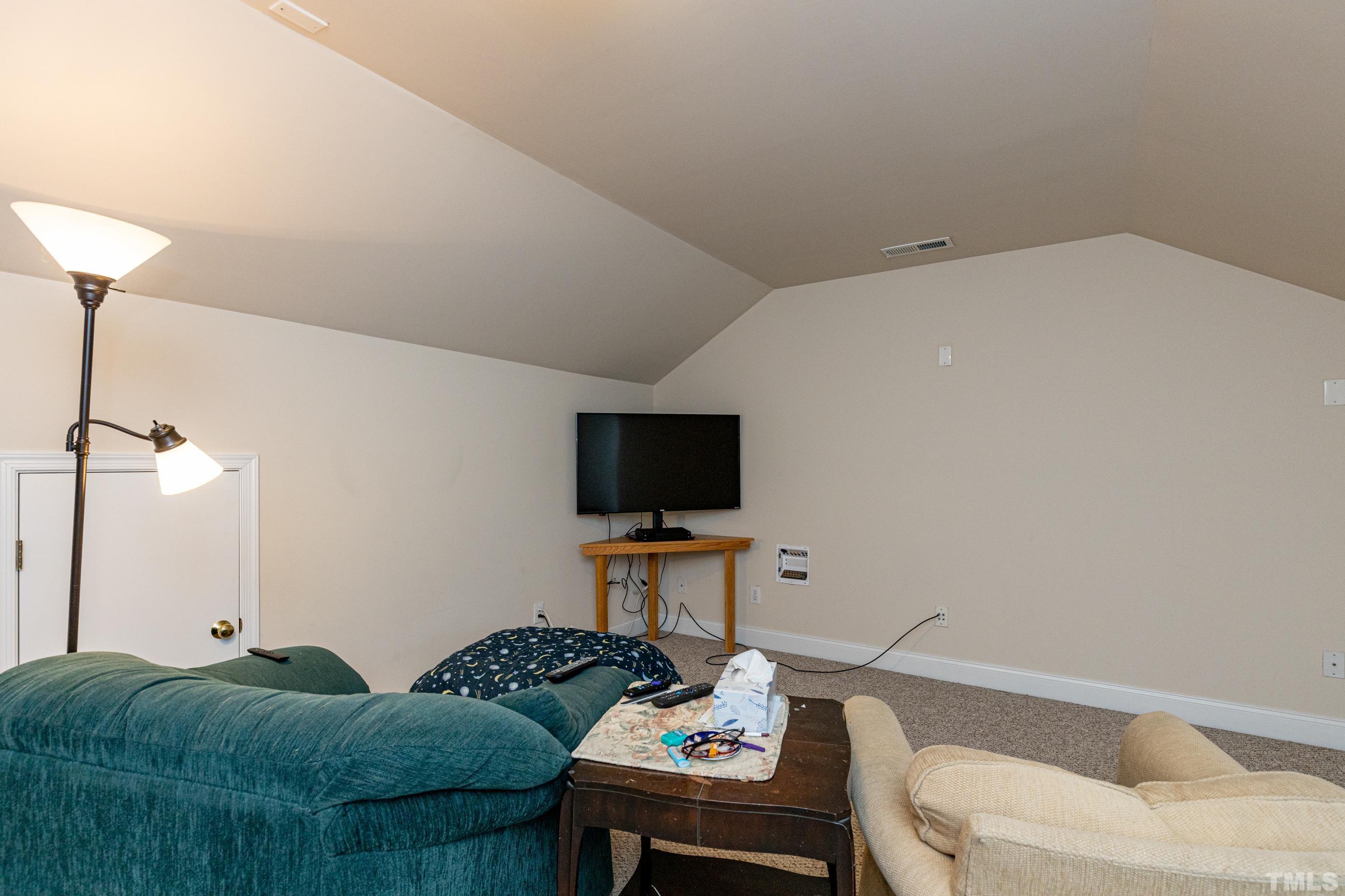 11210 Maplecroft Court Raleigh, NC 27617 - Photo 27 of 30 a living room with furniture and a flat screen tv