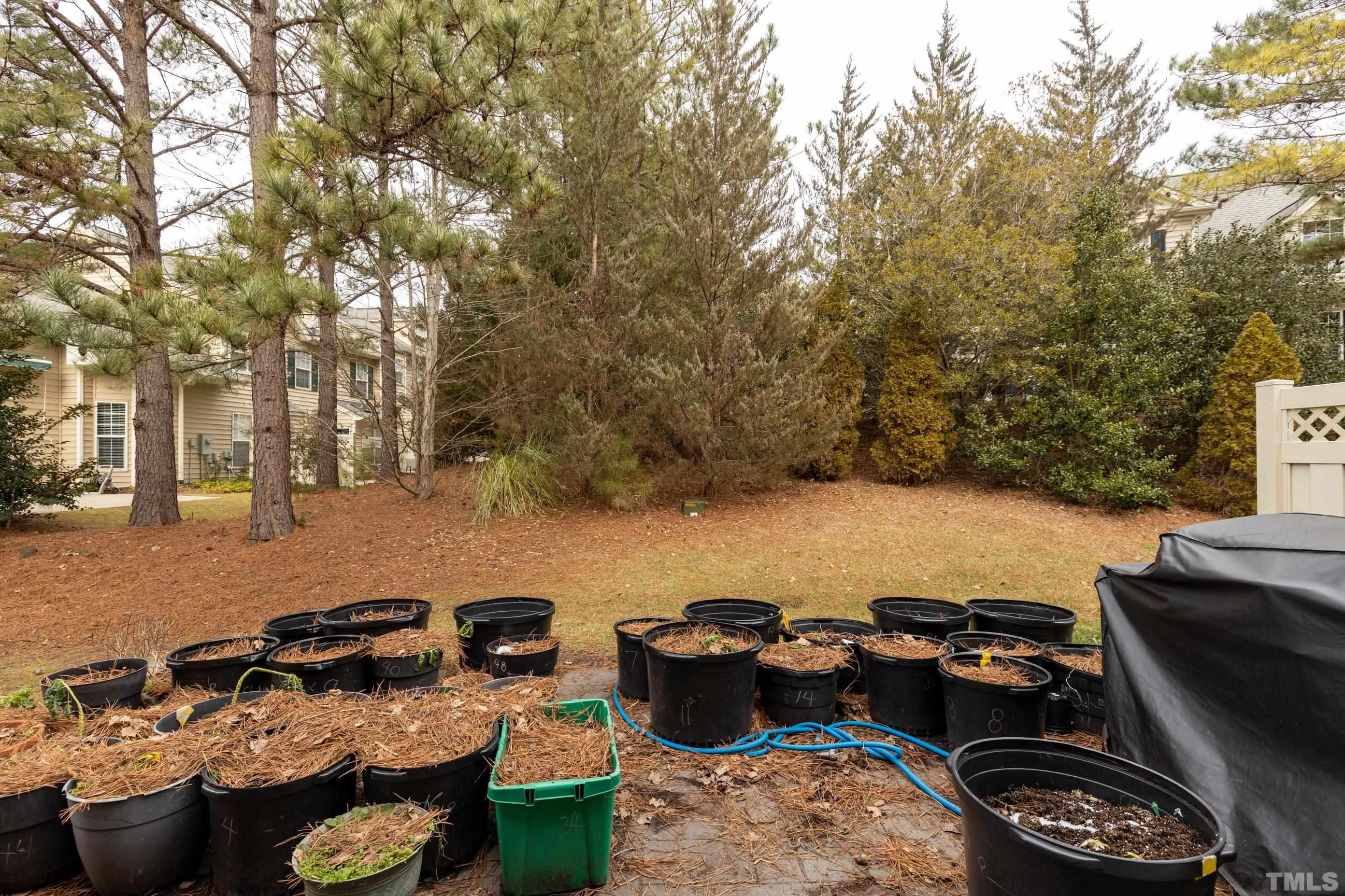 11210 Maplecroft Court Raleigh, NC 27617 - Photo 29 of 30 a backyard of a house with fire pit and outdoor seating