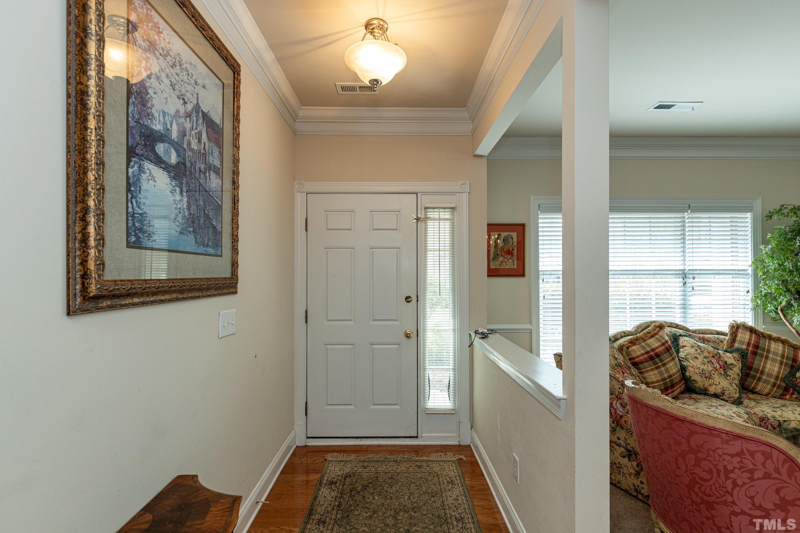 11210 Maplecroft Court Raleigh, NC 27617 - Photo 5 of 30 a view of a hallway to a livingroom with furniture