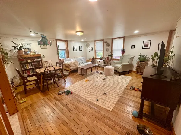 a living room with lots of furniture and wooden floor