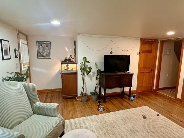 a living room with furniture and wooden floor