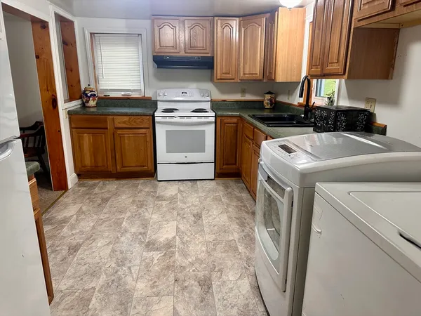 a kitchen with a stove a sink and a refrigerator