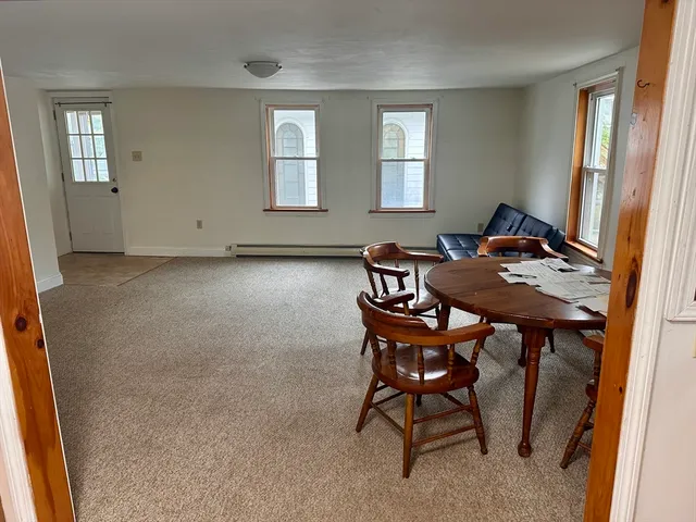 a view of a dining room with furniture and window