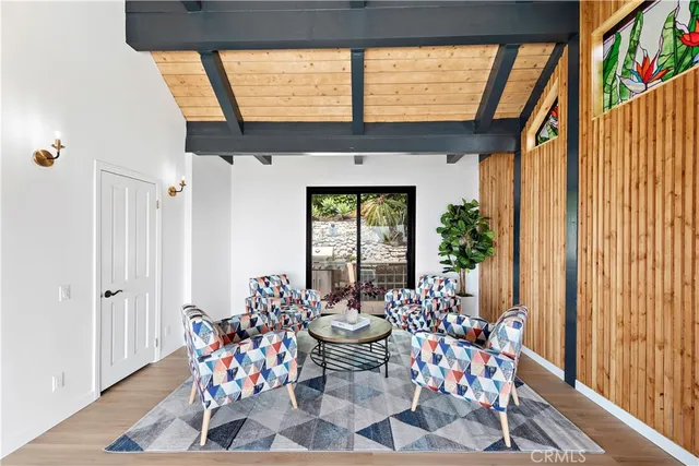 a living room with furniture and a floor to ceiling window