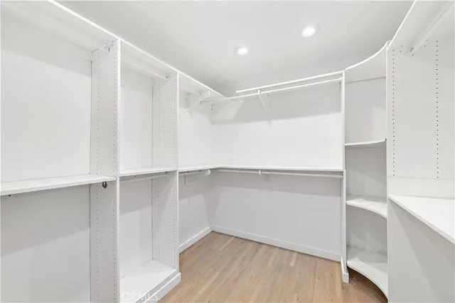 a bedroom with a large bed and a large window