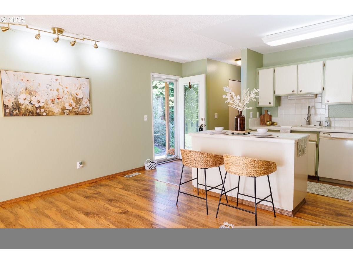 490 North Hayden Island Drive, Unit 98 Portland, OR 97217 - Photo 3 of 21 a kitchen with stainless steel appliances kitchen island granite countertop a sink and cabinets