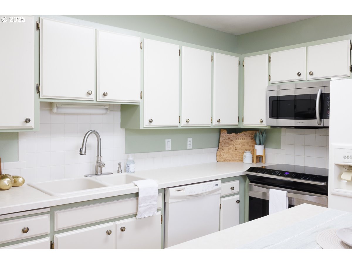 490 North Hayden Island Drive, Unit 98 Portland, OR 97217 - Photo 5 of 21 a kitchen with appliances a sink and cabinets