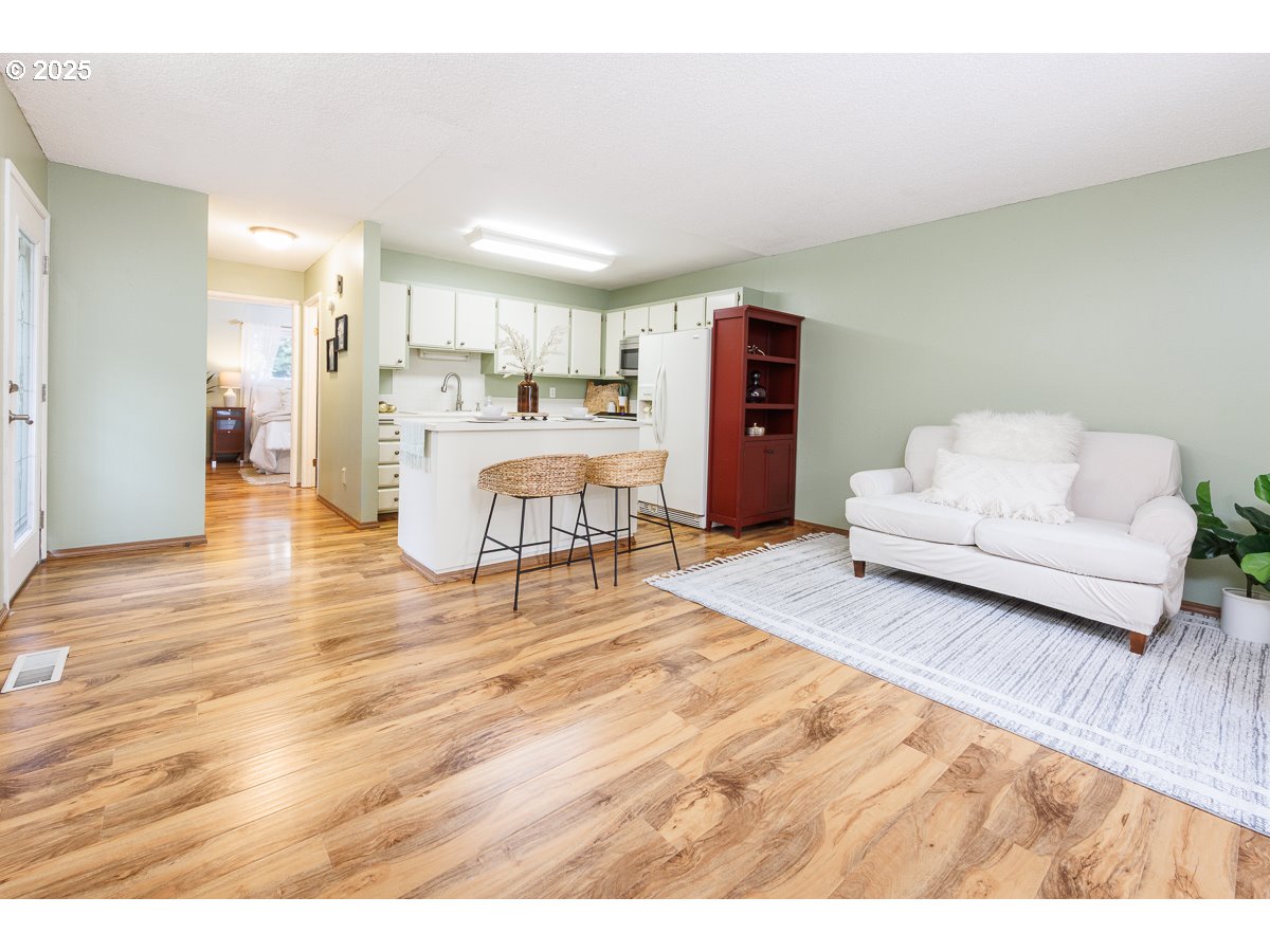 490 North Hayden Island Drive, Unit 98 Portland, OR 97217 - Photo 7 of 21 a living room with furniture and a wooden floor