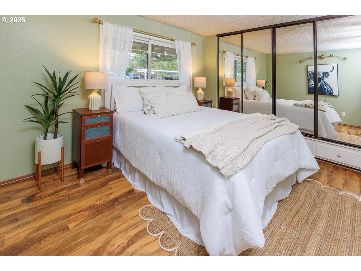 490 North Hayden Island Drive, Unit 98 Portland, OR 97217 - Photo 8 of 21 a spacious bedroom with a balcony a bed and a dresser