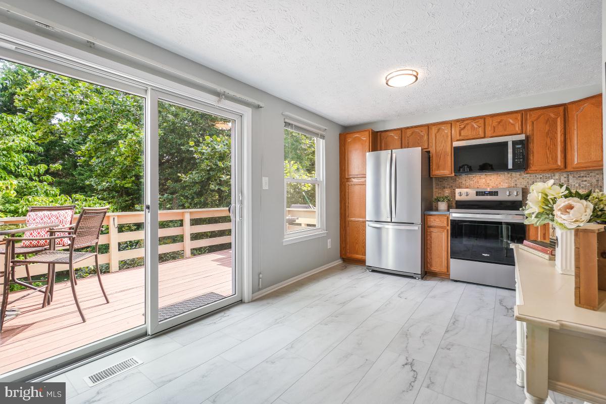 1705 Sundance Drive Reston, VA 20194 - Photo 17 of 29 a kitchen with stainless steel appliances a stove top oven and a refrigerator