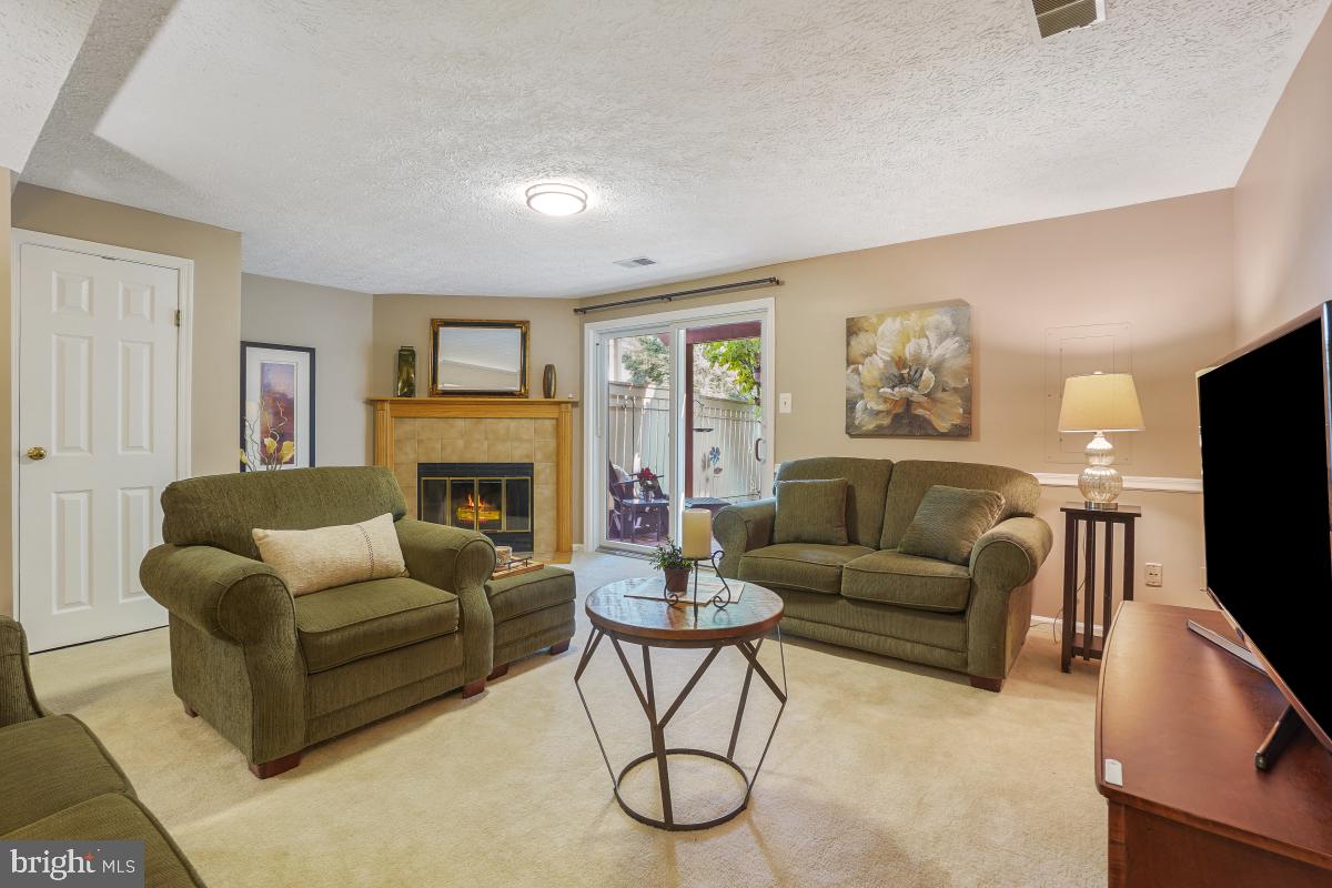 1705 Sundance Drive Reston, VA 20194 - Photo 20 of 29 a living room with furniture a flat screen tv and a fireplace