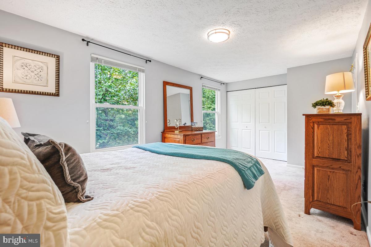 1705 Sundance Drive Reston, VA 20194 - Photo 26 of 29 a bedroom with a bed and a dresser with wooden floor