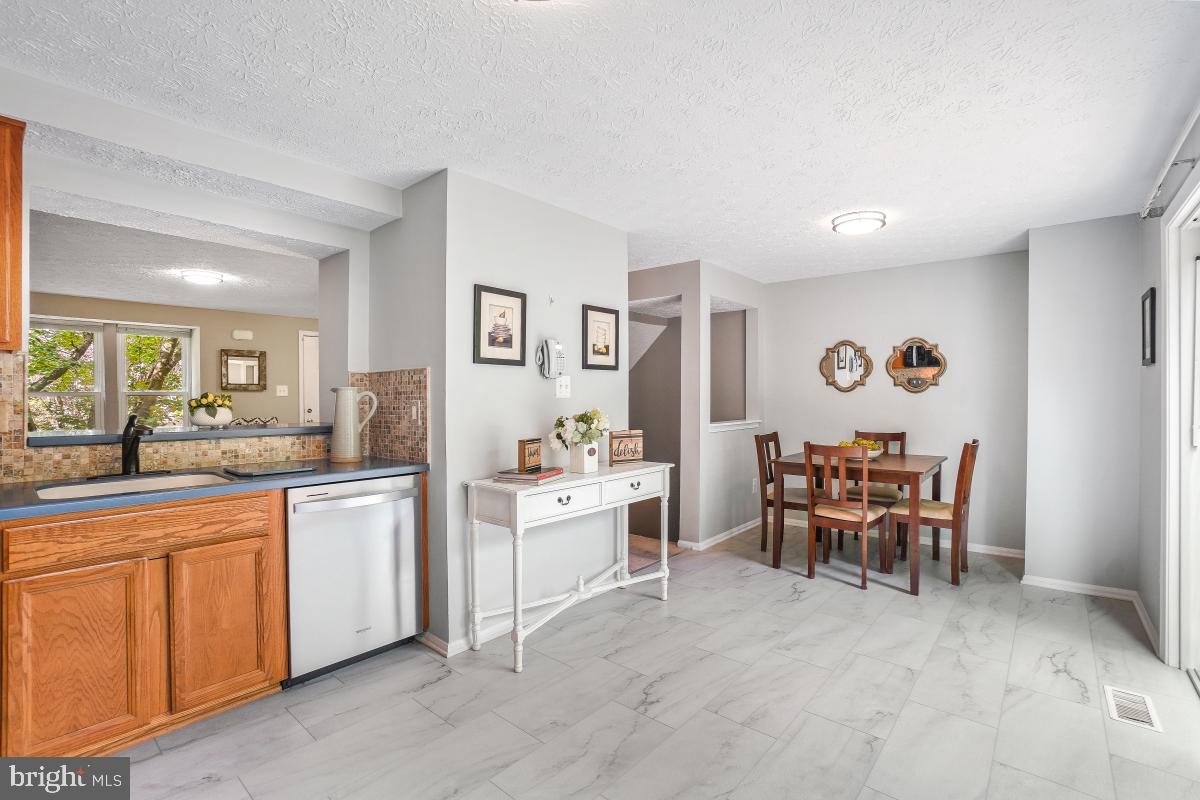 1705 Sundance Drive Reston, VA 20194 - Photo 5 of 29 a view of a dining room with furniture and chandelier
