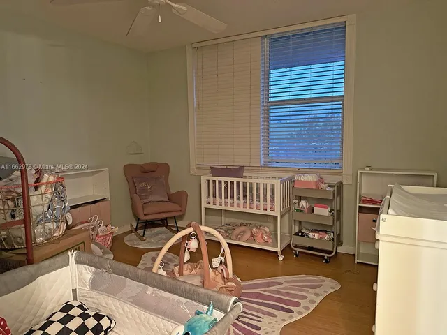 a bathroom with a granite countertop sink a mirror and shower