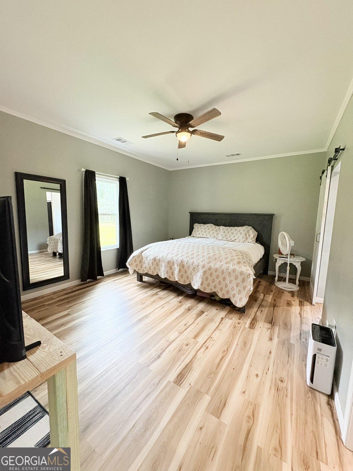 210 St Galilee Road Swainsboro, GA 30401 - Photo 9 of 18 a bedroom with a bed and a chandelier