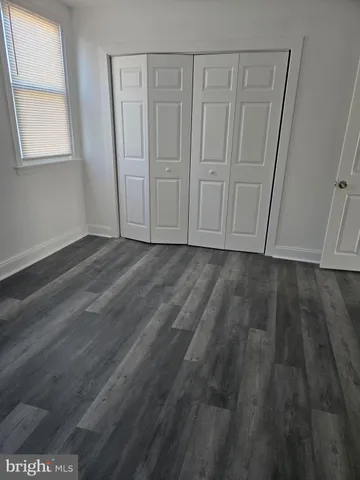 a view of room with wooden floor