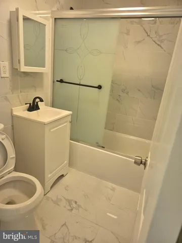 an empty room with wooden floor and closet