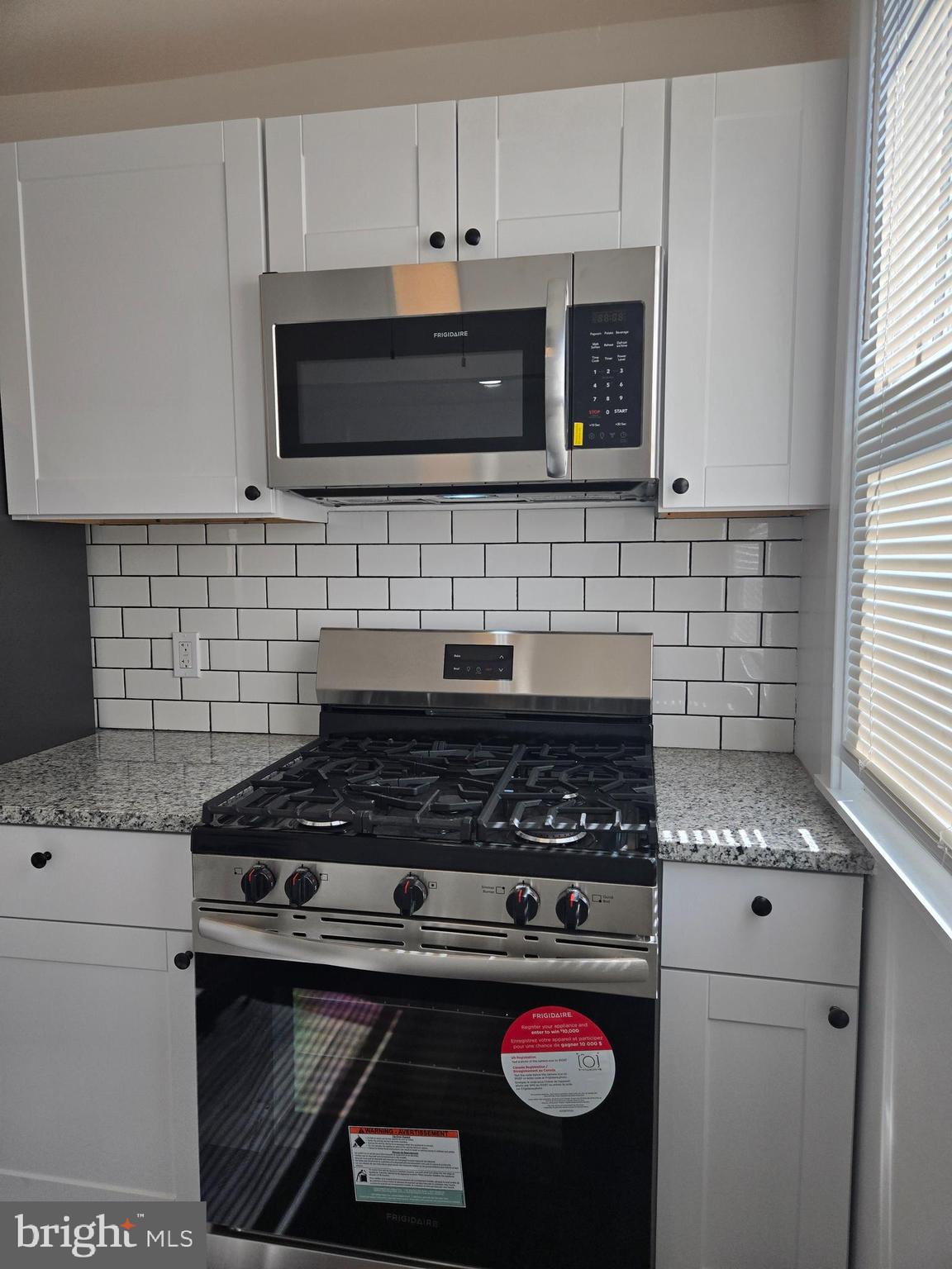 1304 Fanshawe Street Philadelphia, PA 19111 - Photo 9 of 49 a kitchen with stainless steel appliances granite countertop a stove and a microwave