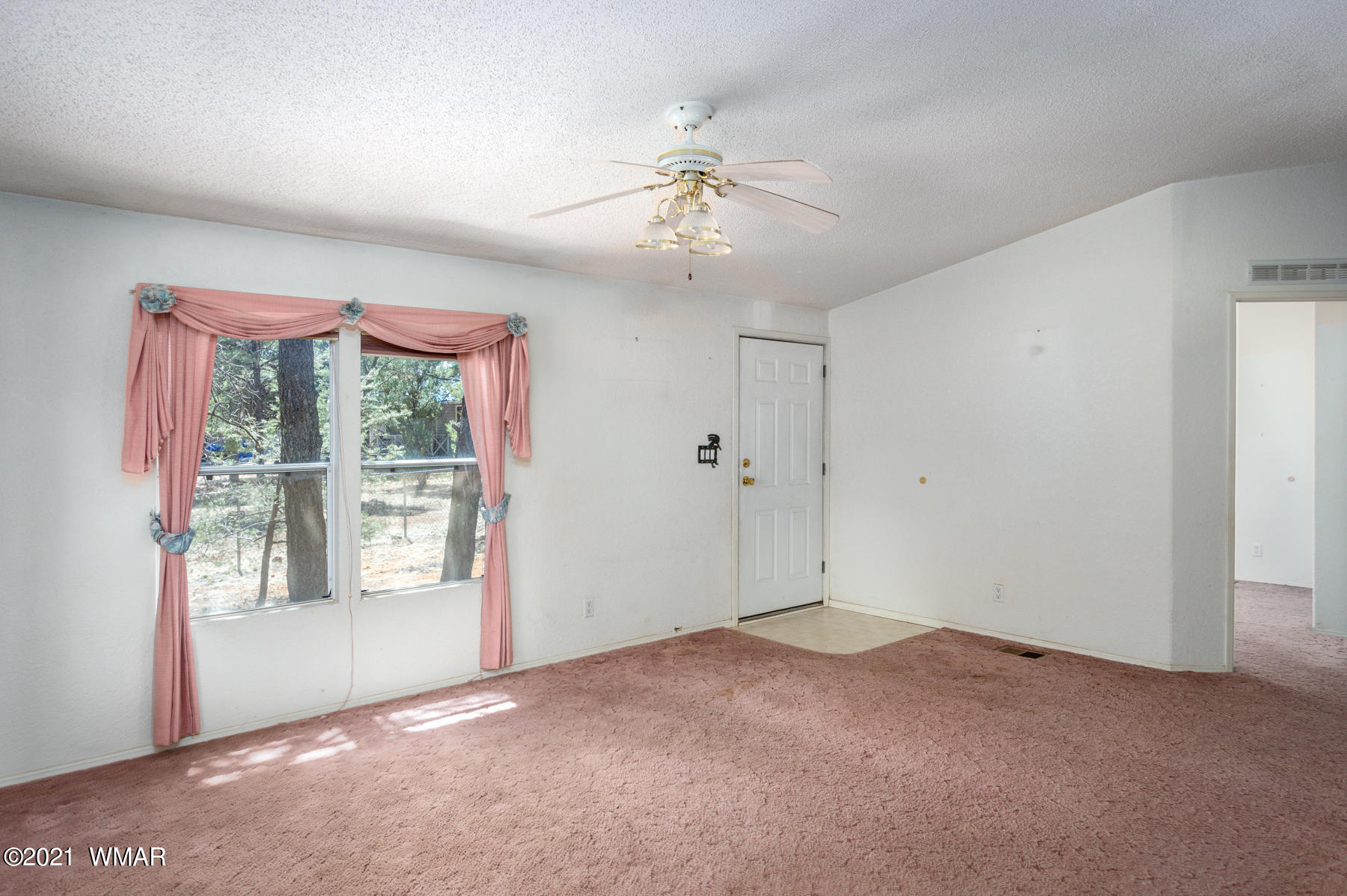 3620 North Buckskin Road Overgaard, AZ 85933 - Photo 1 of 16 a view of an empty room with a window