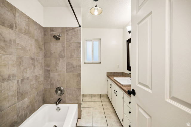 365 South Center Street Fielding, UT 84311 - Photo 18 of 41 Bathroom featuring vanity, shower / bathtub combination, and light tile patterned flooring