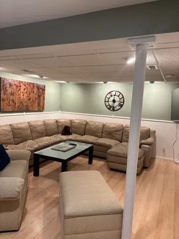 a living room with furniture and a floor to ceiling window