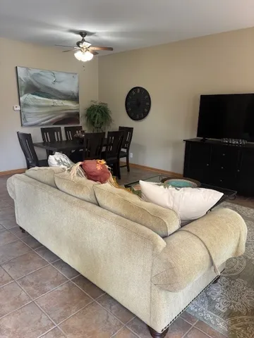 a living room with furniture and a dining table