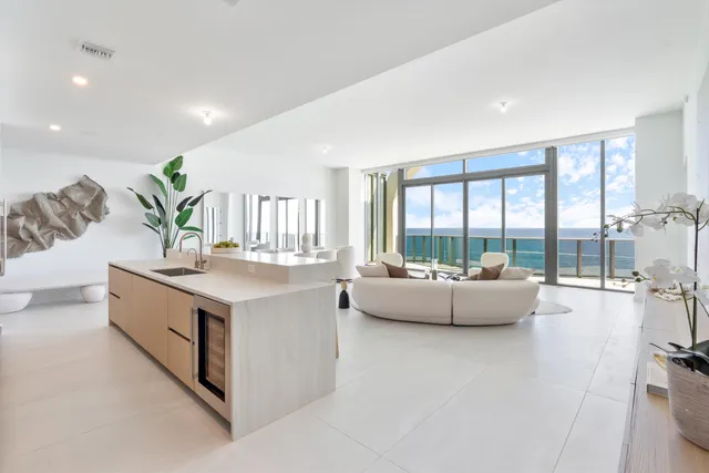 a living room with kitchen island furniture and a large window