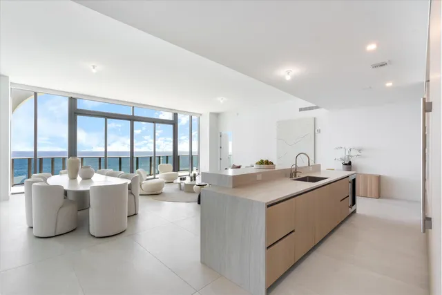 a view of kitchen with stainless steel appliances granite countertop a sink and cabinets