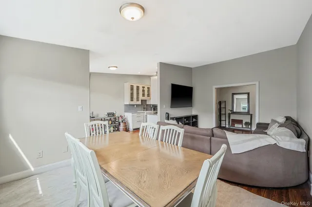 a dining room with furniture and wooden floor